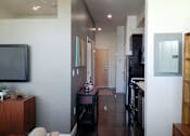 Thumbnail 24 of 36 - Modern entryway with dark accent wall and hardwood floors at 68 Beale Apartments, Massachusetts